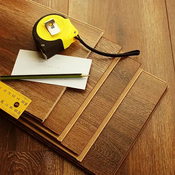 stacked flooring with tools for measuring